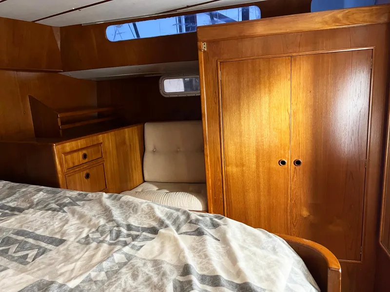 Slide: The Image of Interior of 1987 Oyster 46.5 yacht with wooden cabinetry and cozy seating area. - 23