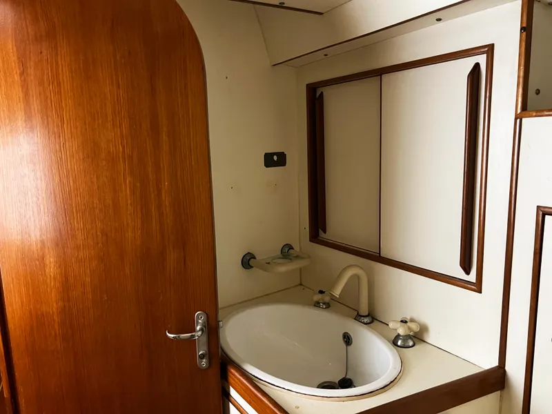 Slide: The Image of Interior of 1987 Oyster 46.5 yacht bathroom with wooden door and sink. - 26