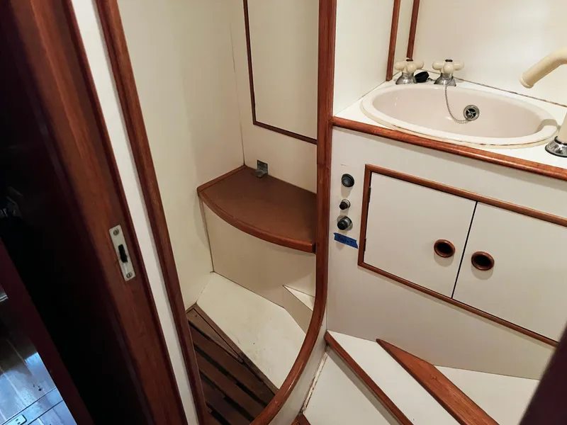 Slide: The Image of Interior of 1987 Oyster 46.5 yacht bathroom with sink and wooden accents. - 30