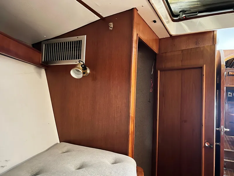 Slide: The Image of Interior of 1987 Oyster 46.5 yacht with wood paneling and cozy cabin space. - 33