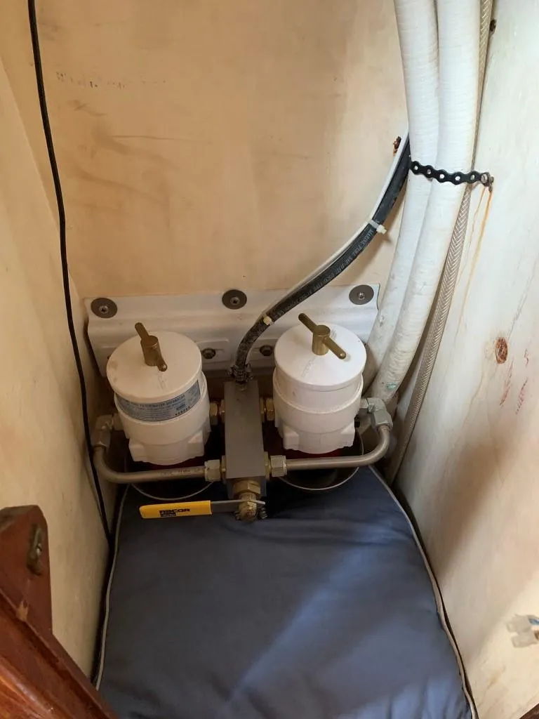 Slide: The Image of 1987 Oyster 46.5 yacht engine compartment with dual fuel filters and hoses. - 35