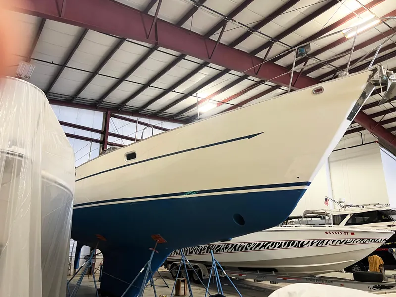 Slide: The Image of Oyster 46.5 sailboat from 1987 in a boatyard, elevated on stands. - 36