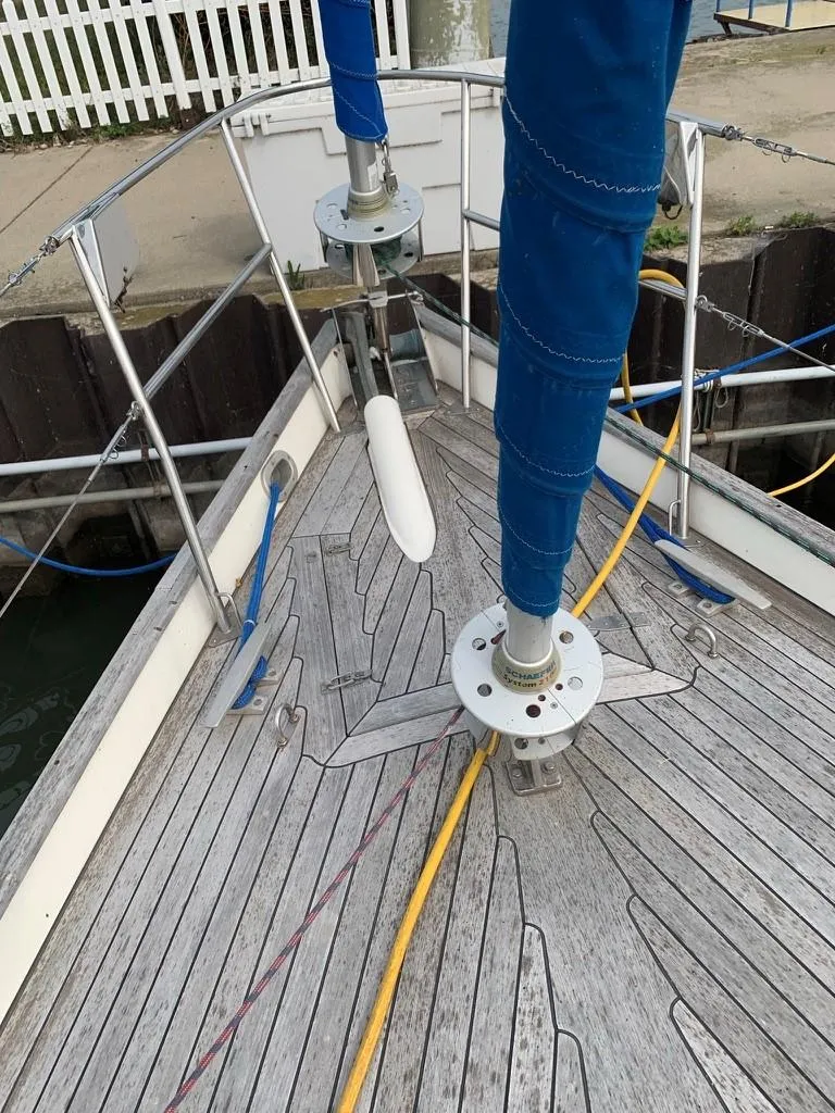 Slide: The Image of 1987 Oyster 46.5 sailboat deck with blue sail covers and mooring lines. - 6