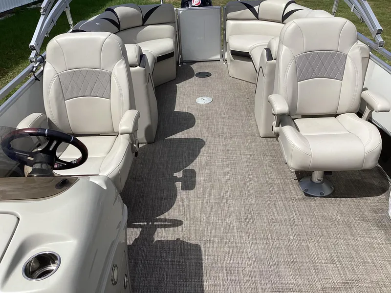 Slide: The Image of 2018 Berkshire 23RFX STS 2.0 pontoon boat interior with beige seating and carpet. - 12