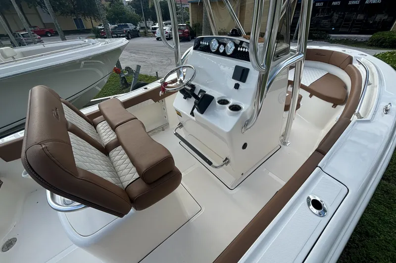 Slide: The Image of 2025 Pioneer 202 Sportfish boat interior with brown seating and modern console. - 14