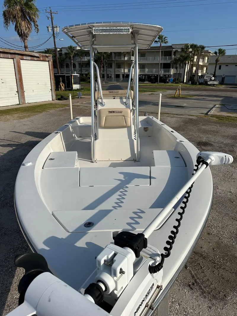 Slide: The Image of 2010 Pathfinder 2200-V boat with T-top, parked outdoors on a sunny day. - 2