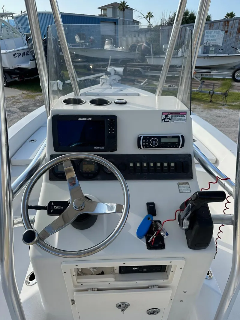 Slide: The Image of 2010 Pathfinder 2200-V boat console with steering wheel, navigation system, and controls. - 3