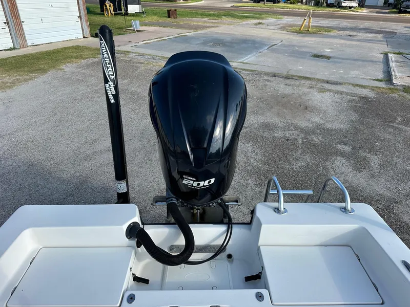 Slide: The Image of 2010 Pathfinder 2200-V boat with a 200 horsepower engine, parked on a concrete surface. - 6