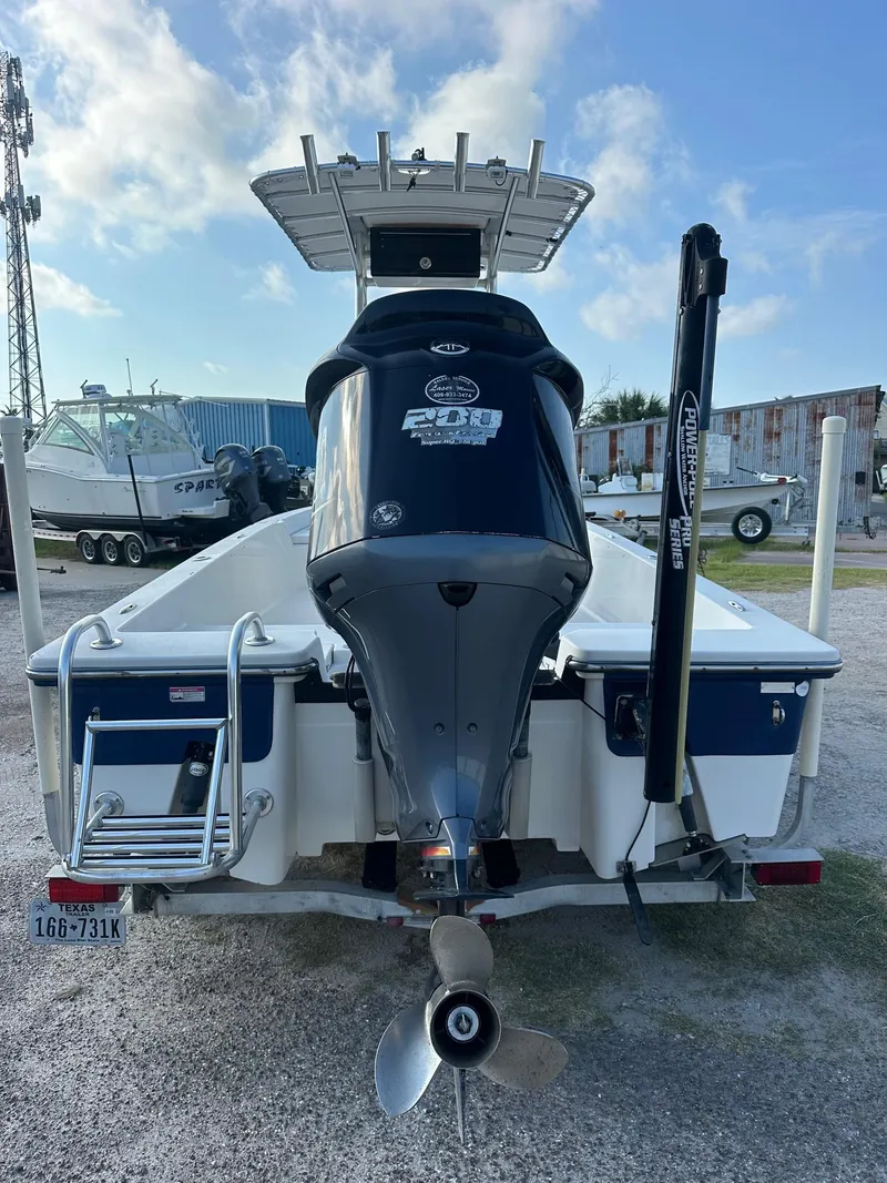 Slide: The Image of 2010 Pathfinder 2200-V boat, rear view with motor and ladder, parked outdoors. - 8