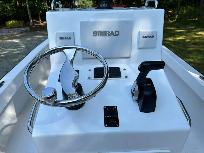 Slide: The Image of 2020 ROS Boats 20 Center Console dashboard with Simrad electronics and steering wheel. - 4