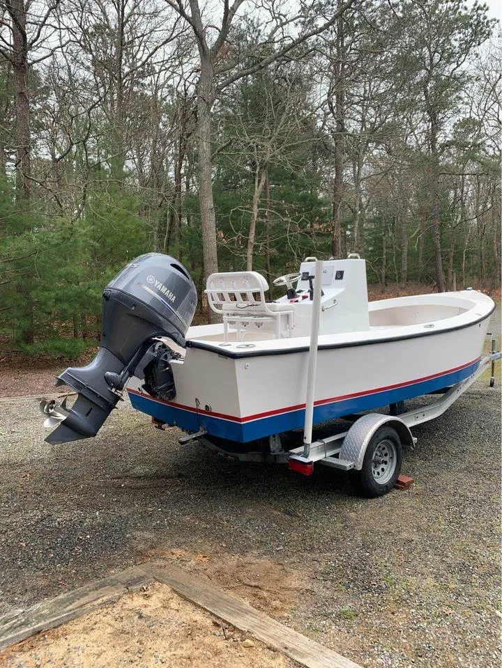 Slide: The Image of 2020 ROS Boats 20 Center Console on trailer, featuring outboard motor, parked in wooded area. - 5