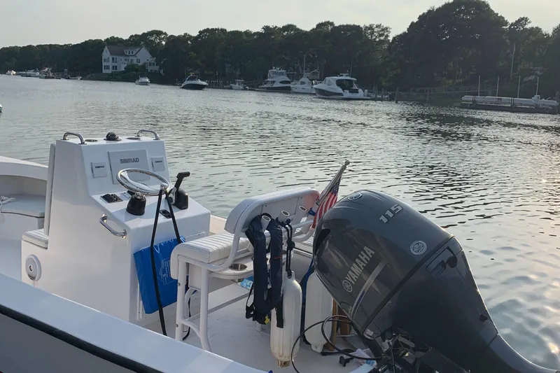 Slide: The Image of 2020 ROS Boats 20 Center Console on calm water, featuring Yamaha outboard motor. - 7