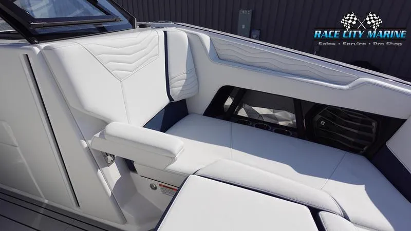 Slide: The Image of 2025 Nautique Super Air Nautique G23 interior with white leather seating. - 12