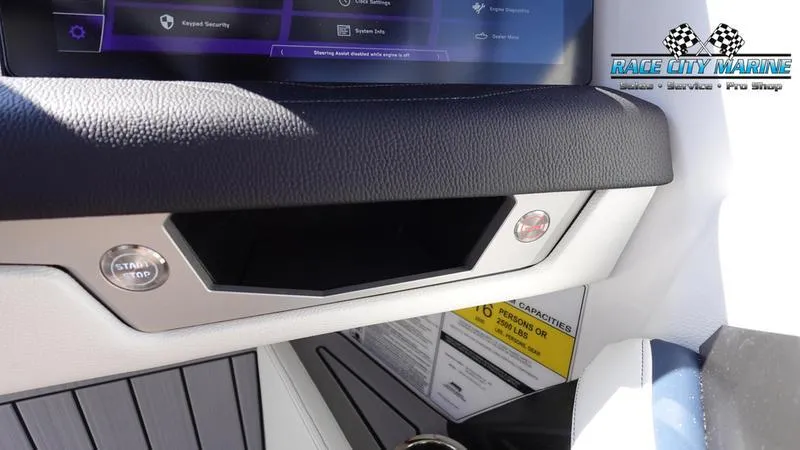 Slide: The Image of 2025 Nautique Super Air Nautique G23 dashboard with start button and display screen. - 13