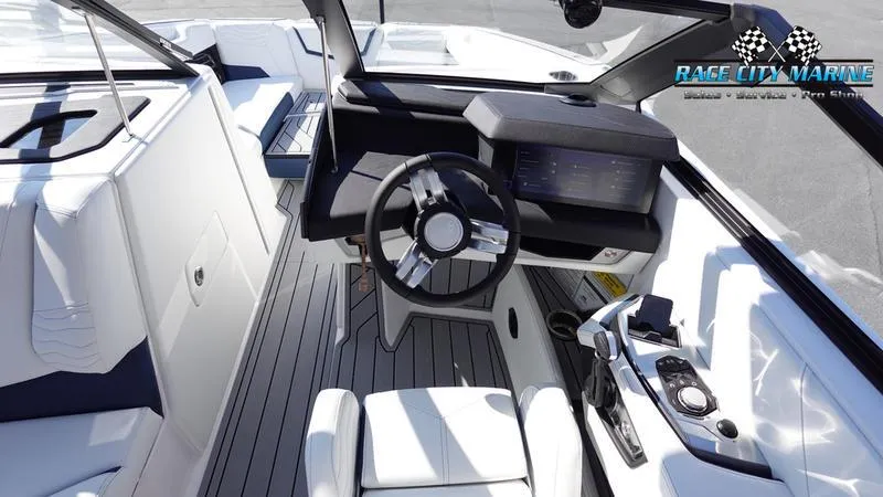 Slide: The Image of 2025 Nautique Super Air Nautique G23 boat interior with modern dashboard and steering wheel. - 14