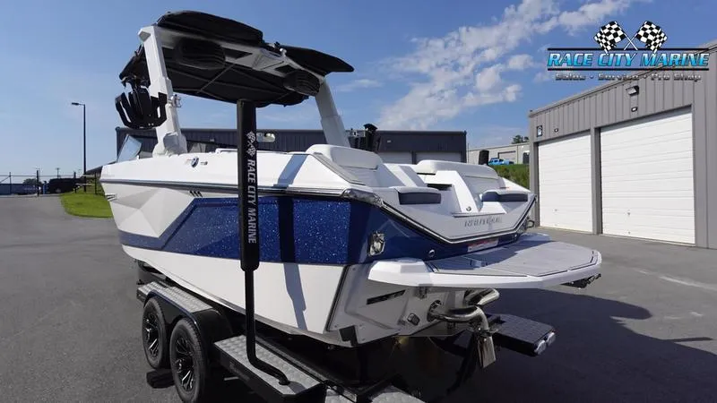 Slide: The Image of 2025 Nautique Super Air Nautique G23 boat on trailer, parked outside Race City Marine. - 2