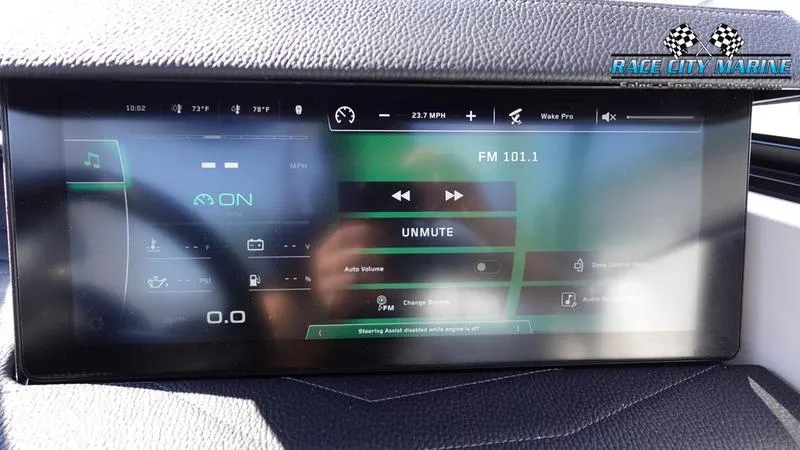 Slide: The Image of 2025 Nautique Super Air Nautique G23 dashboard display showing audio controls and speed. - 21