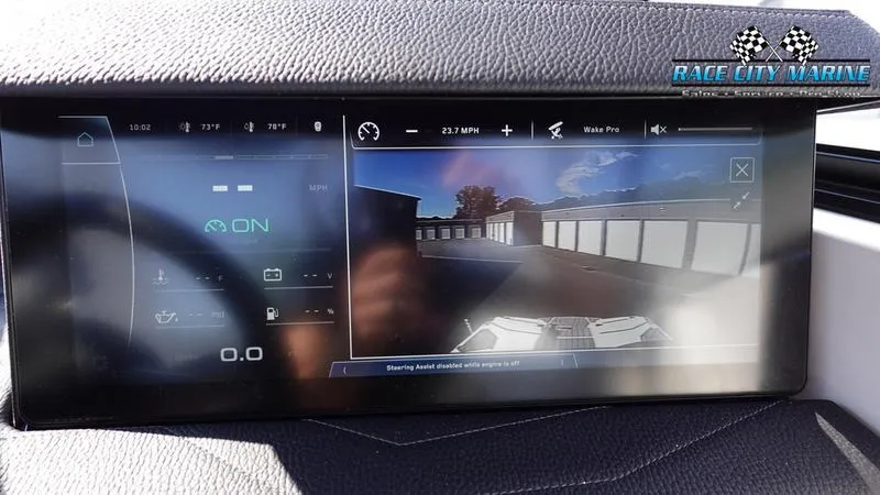 Slide: The Image of 2025 Nautique Super Air Nautique G23 dashboard display with navigation and control features. - 23