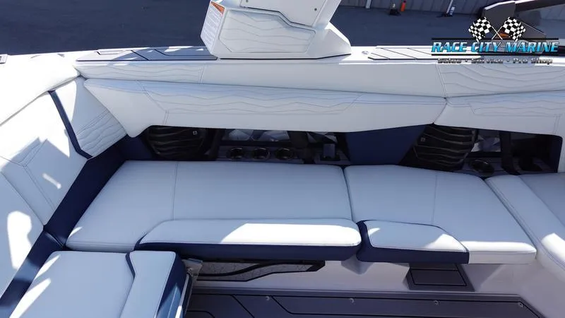 Slide: The Image of 2025 Nautique Super Air Nautique G23 interior seating, luxurious white upholstery. - 25