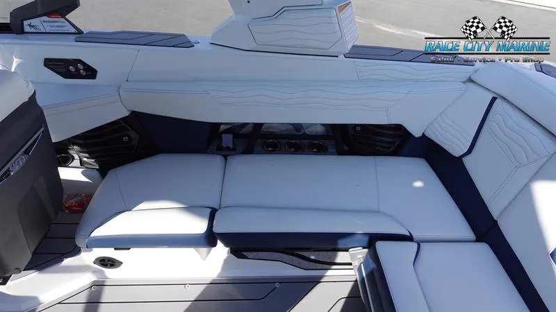 Slide: The Image of 2025 Nautique Super Air Nautique G23 interior seating, white and navy upholstery, Race City Marine logo. - 27