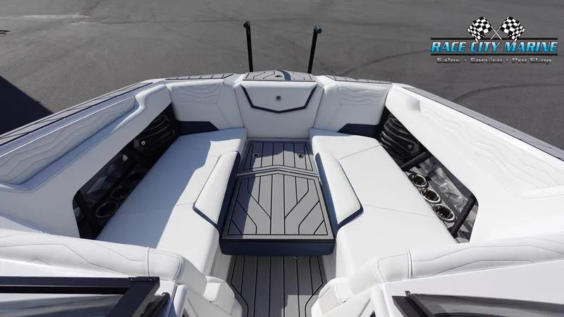 Slide: The Image of 2025 Nautique Super Air Nautique G23 boat interior with white seating and sleek design. - 28