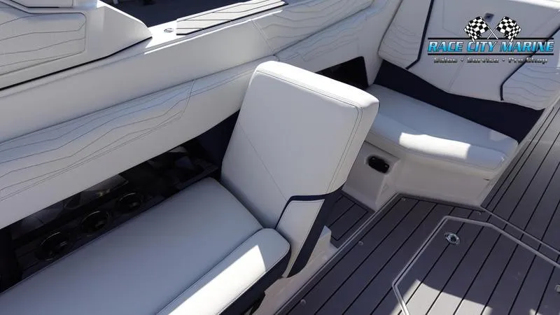 Slide: The Image of 2025 Nautique Super Air Nautique G23 interior with sleek white seating and modern design. - 29