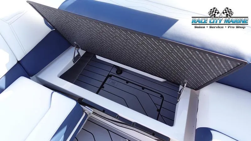 Slide: The Image of 2025 Nautique Super Air Nautique G23 storage compartment with Race City Marine logo. - 30