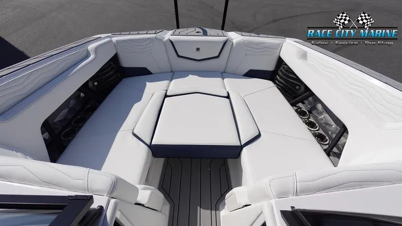 Slide: The Image of 2025 Nautique Super Air Nautique G23 boat interior with white seating and cup holders. - 35