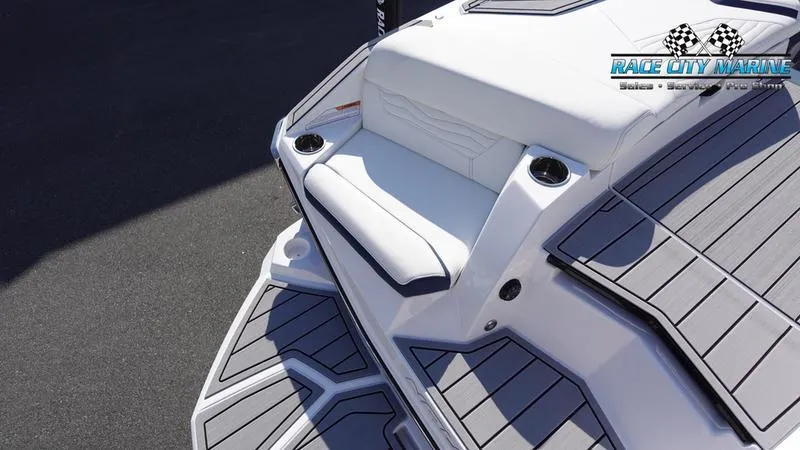 Slide: The Image of 2025 Nautique Super Air Nautique G23 boat, white and gray seating, Race City Marine logo. - 38