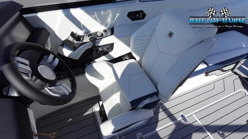 Slide: The Image of 2025 Nautique Super Air Nautique G23 interior with sleek white seating and modern controls. - 42