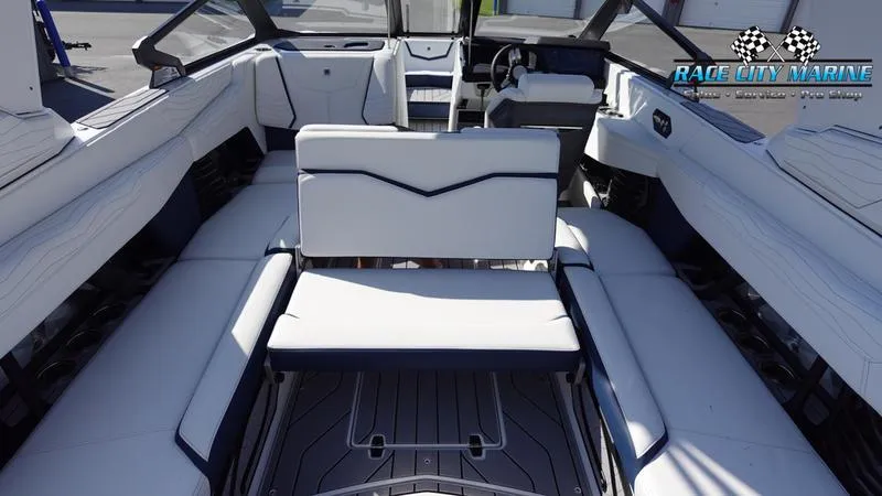 Slide: The Image of 2025 Nautique Super Air Nautique G23 interior with luxurious white seating and modern design. - 44