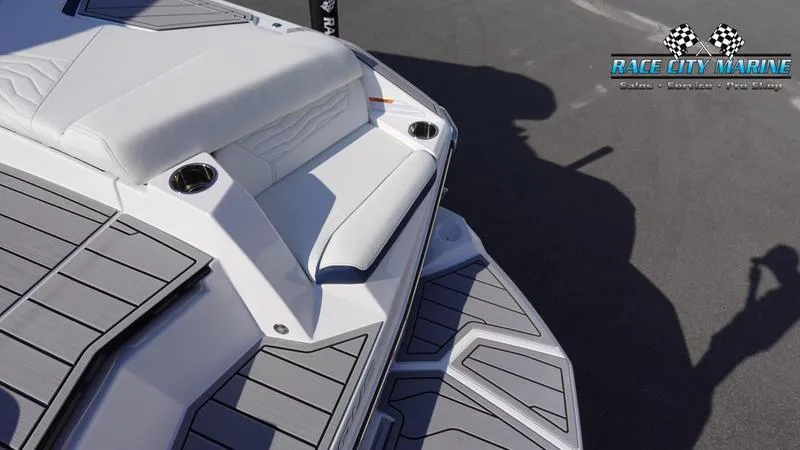 Slide: The Image of 2025 Nautique Super Air Nautique G23 boat deck with cushioned seating and cup holders. - 45