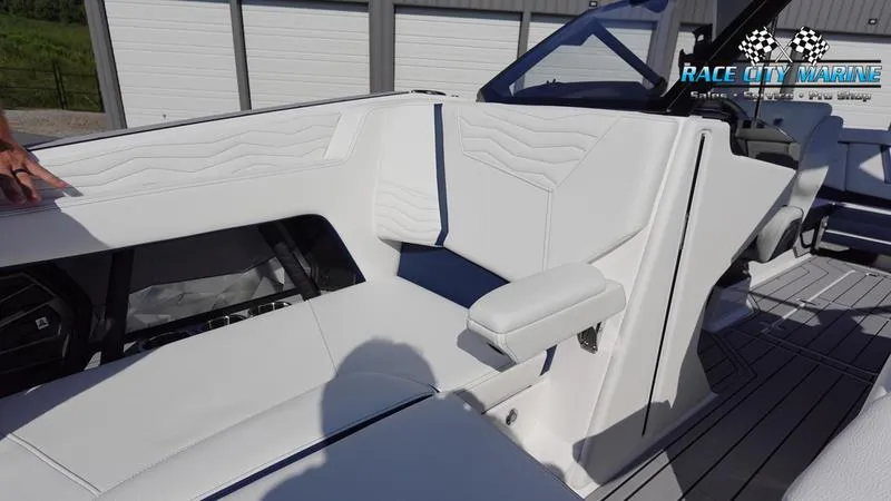 Slide: The Image of 2025 Nautique Super Air Nautique G23 interior with white seating and modern design. - 48