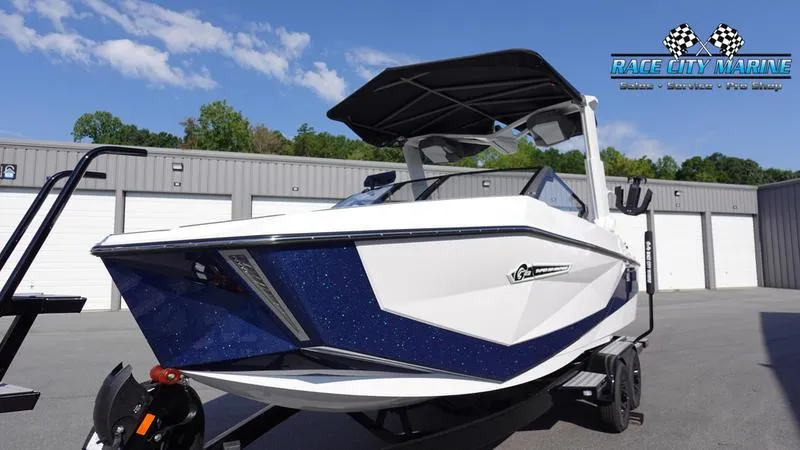 Slide: The Image of 2025 Nautique Super Air Nautique G23 boat in a marina setting. - 5
