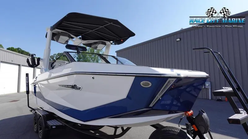 Slide: The Image of 2025 Nautique Super Air Nautique G23 boat in blue and white at Race City Marine. - 6