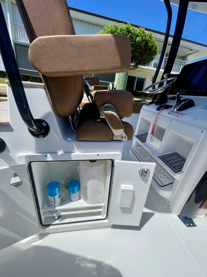 Slide: The Image of 2023 Sea Hunt Ultra 255 SE boat interior with storage compartment open. - 10