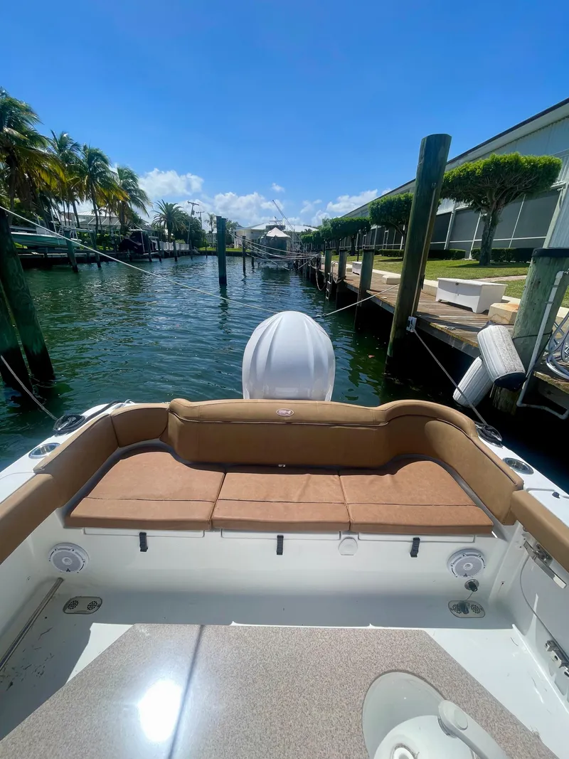 Slide: The Image of 2023 Sea Hunt Ultra 255 SE boat docked in sunny marina. - 13