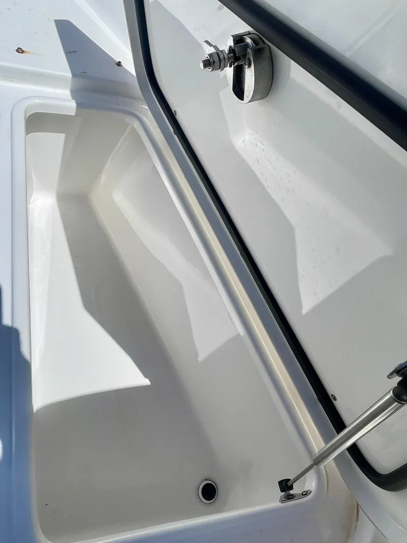 Slide: The Image of Open storage compartment on 2023 Sea Hunt Ultra 255 SE boat. - 16