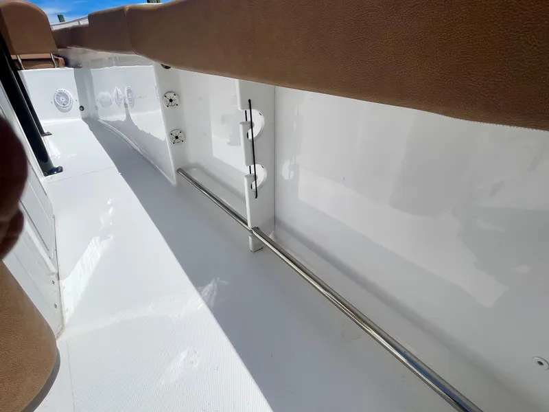 Slide: The Image of 2023 Sea Hunt Ultra 255 SE boat interior with sleek white finish and brown accents. - 17