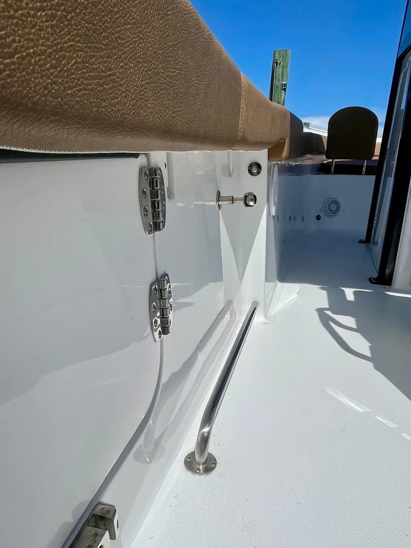 Slide: The Image of 2023 Sea Hunt Ultra 255 SE boat interior with sleek white finish and stainless steel fittings. - 18