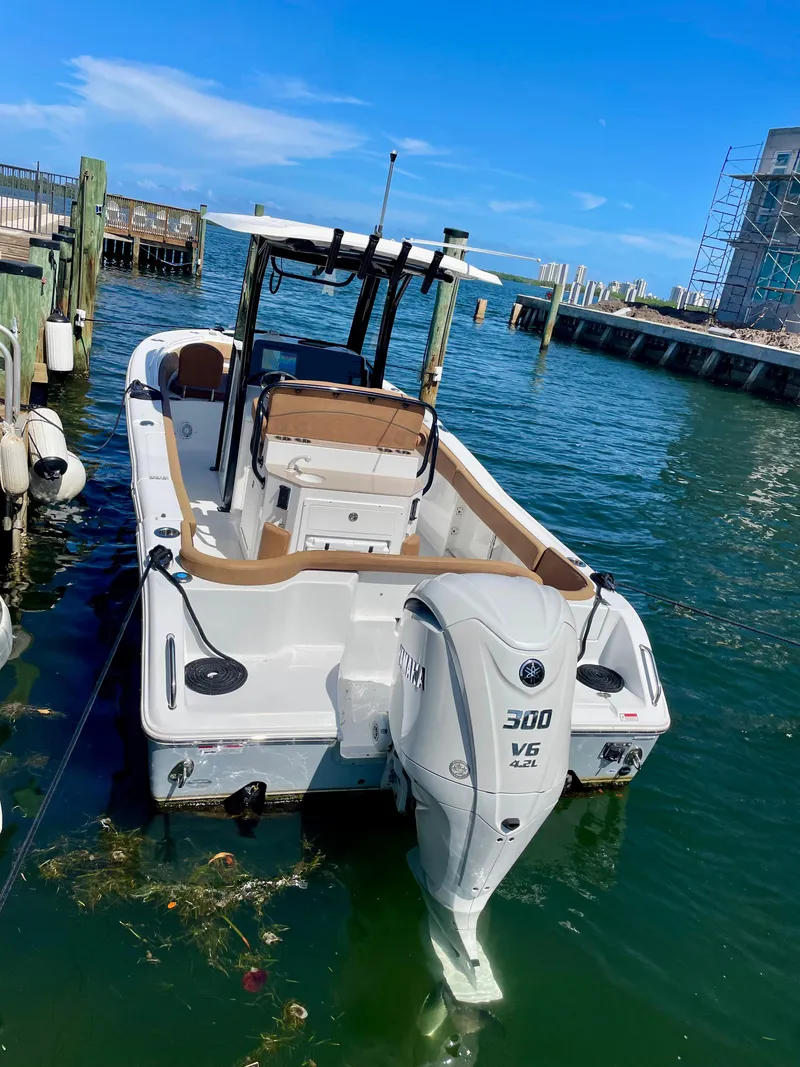 Slide: The Image of 2023 Sea Hunt Ultra 255 SE boat docked in marina, featuring a 300 V6 engine. - 20