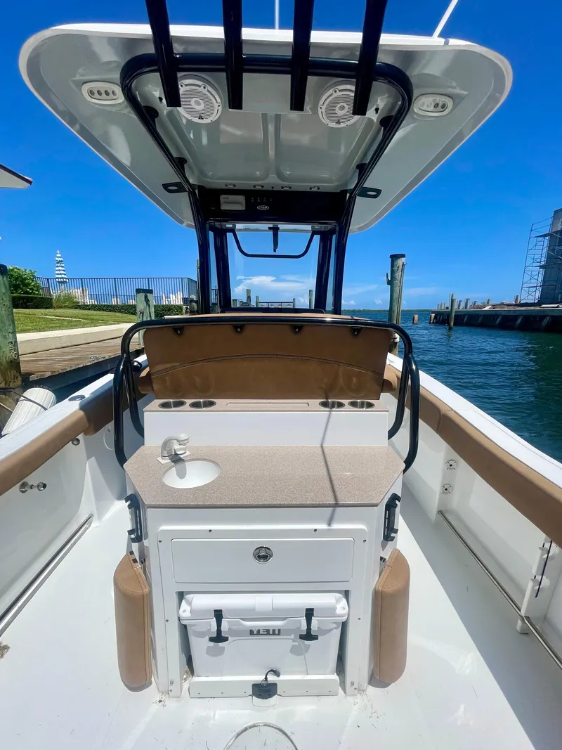 Slide: The Image of 2023 Sea Hunt Ultra 255 SE boat interior with console and seating. - 5