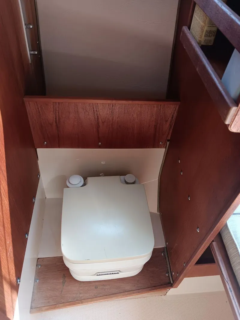 Slide: The Image of 1985 Catalina Fin Keel boat interior with compact portable toilet. - 4