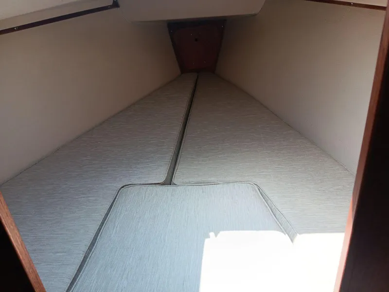 Slide: The Image of Interior view of 1985 Catalina Fin Keel sailboat cabin with cushioned sleeping area. - 9