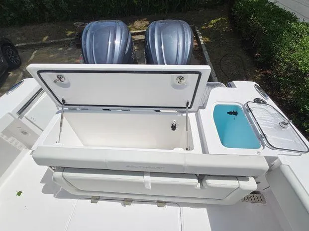 Slide: The Image of 2026 Southport 30FE boat interior with dual Garmin displays and plush seating. - 10