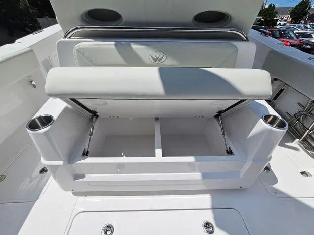 Slide: The Image of 2026 Southport 30FE boat interior with white seating and table in a garage setting. - 12