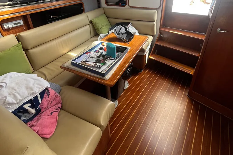 Slide: The Image of Interior of 1990 Tiara Yachts 3100 with beige seating and wooden flooring. - 14