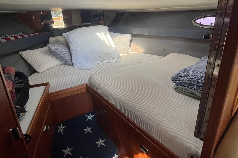 Slide: The Image of Cozy cabin interior of 1990 Tiara Yachts 3100 with comfortable bedding. - 16