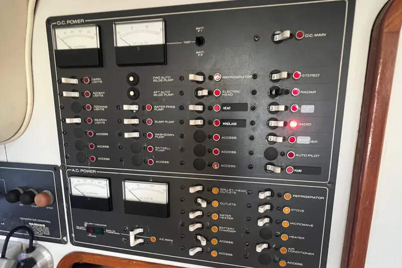 Slide: The Image of Control panel of a 1990 Tiara Yachts 3100, featuring DC and AC power switches. - 17
