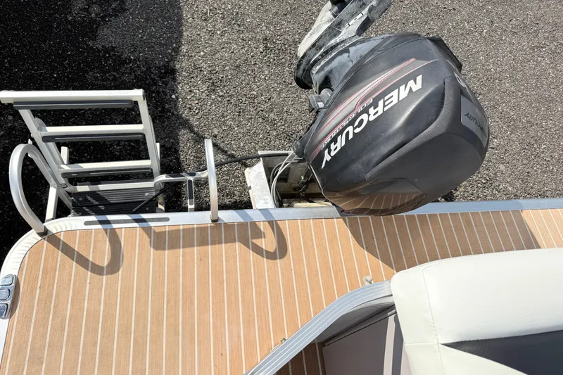 Slide: The Image of 2014 Harris FloteBote 20 with Mercury outboard motor and swim ladder on deck. - 13